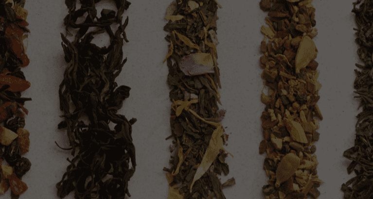 Six colourful loose leaf teas beautifully displayed in vertical lines.